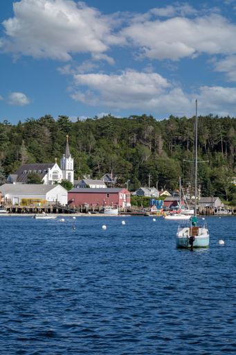 A vertical shot of ships sailing at the Boothbay Harbor, Maine, USA