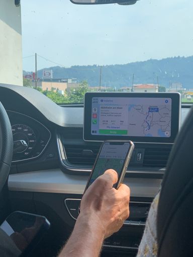 A vertical shot of a driver calculating the distance to destination from Turin, Italy with GPS