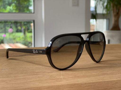The designer sunglasses on a wooden table