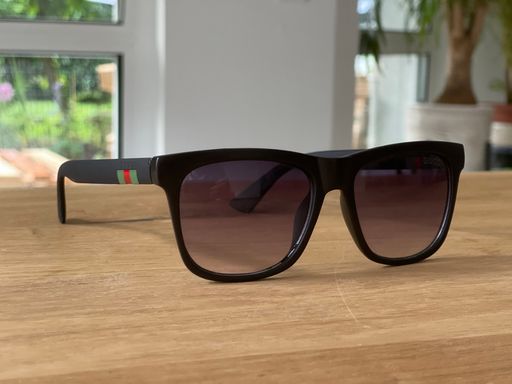 The designer sunglasses on a wooden table