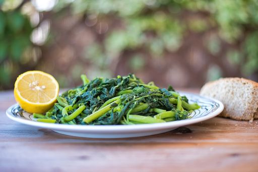 Amaranthus blitum . Vlita Salad (Amaranth Greens) on a plate, on a wooden old table