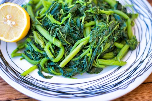 Amaranthus blitum . Vlita Salad (Amaranth Greens) on a plate, on a wooden old table