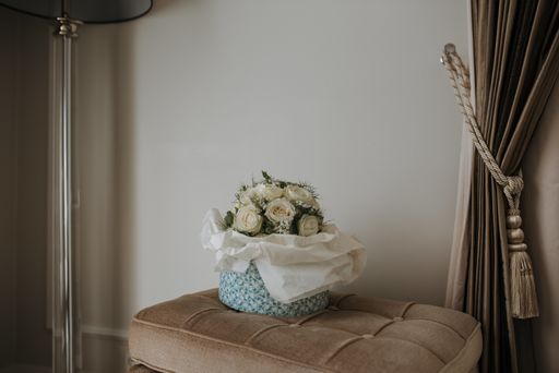 A beautiful shot of a white rose bouquet on a chair in a room