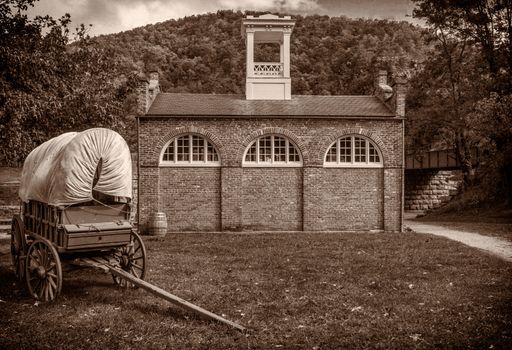 A sepia shot of Harper's Ferry Firehouse and covered wagon in West Virginia