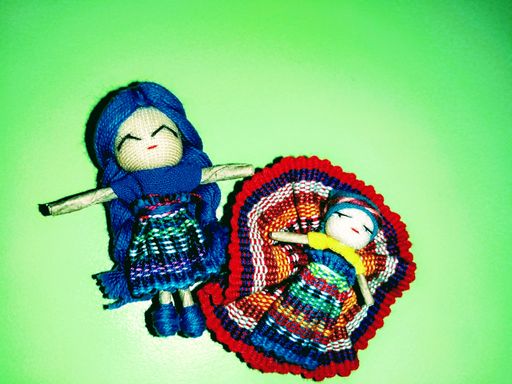 Close-up of a traditional Guatemalan worry doll with painted features