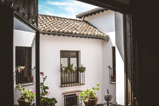 A charming courtyard view with potted plants and traditional Spanish architecture