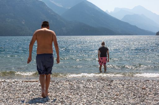 A closeup of two men on the shore.