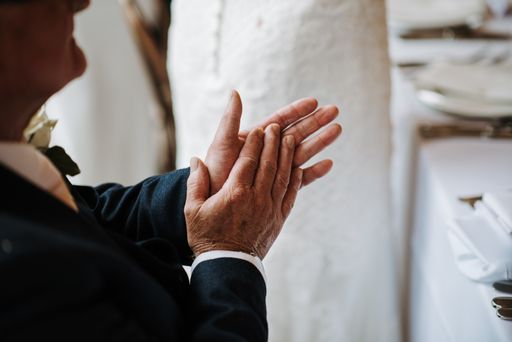 A closeup shot of an old male hands clapping