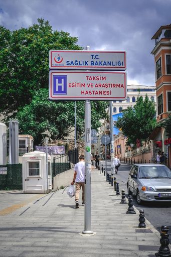 A vertical shot of the Taksim Training and Research Hospital road sign in Istanbul, Turkey