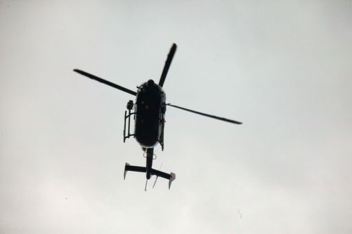 Metropolitan Police helicopter flying over a field in Stansted, UK