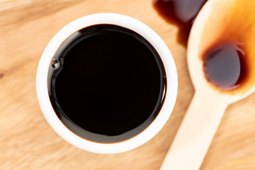 A Top view of Soy sauce in bowl on wooden table still life
