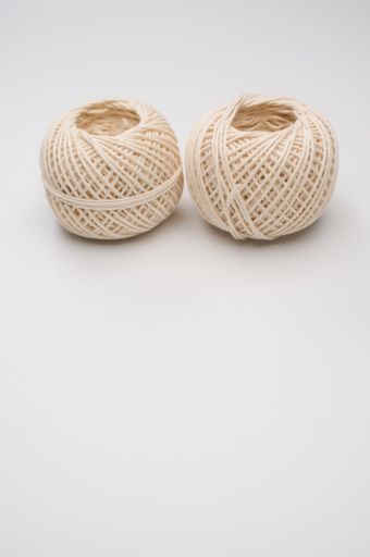 A vertical shot of jute twine balls isolated on white background