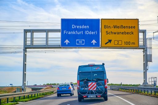 Freeway 10, Germany - September 15, 2019: Camper with a bike carrier attached to the stern and a bicycle mounted on it.