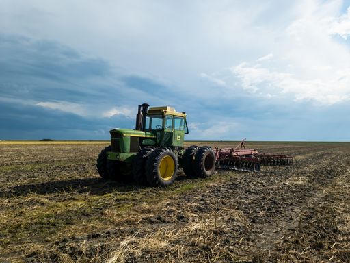 Big green John Deere tractor on a field