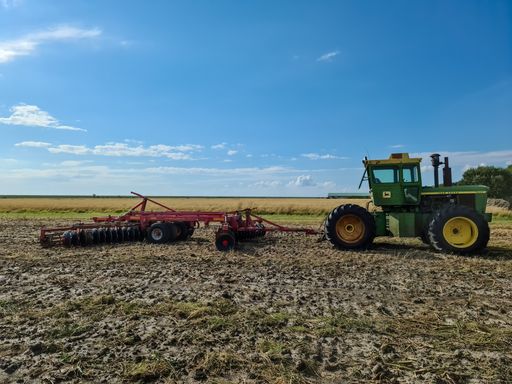 Big green John Deere tractor on a field