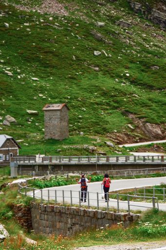 A vertical shot of a concrete trail at the foot of a mountain at the Gran Paradiso National Park in the Italian Alps