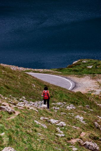 A vertical shot of a hiker in the Gran Paradiso National Park in the Italian Alps