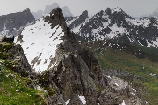 A beautiful view of high rocky mountains partly covered by snow