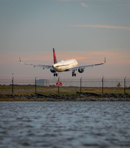 Delta Airlines plane approaching Reagan National Airport at sunset