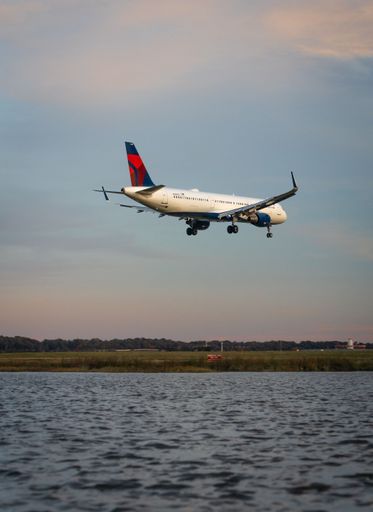 Delta Airlines plane approaches Reagan National Airport at sunset