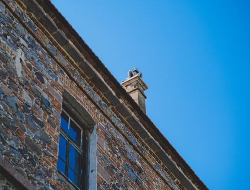 A closeup of a brick wall of a building against the blue sky