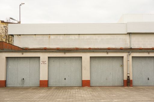 A row of garages with locked doors on a cloudy day in Poznan, Poland
