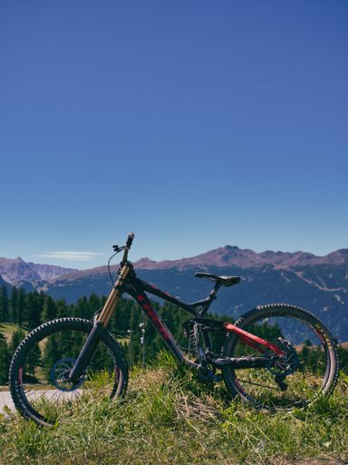A vertical shot of a mountain bike on a hill under the sunlight in Sestriere, Italy