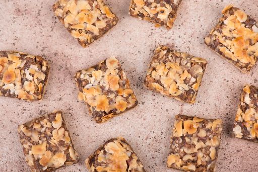 Confectioneries with nuts and chocolate, german christmas sweets, little cakes on a brown textured background, empty copy space for text