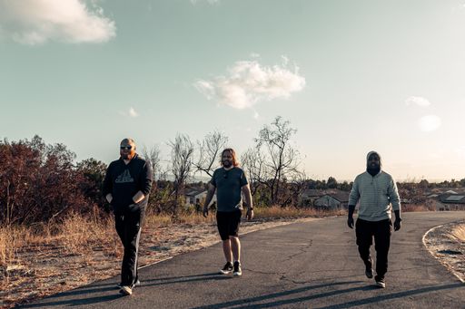 Three cheerful guys walking during sunset in Irvine, California, USA