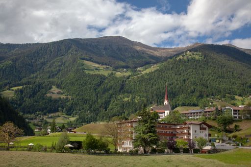 Small rural settlements in the Alps among green hills and forests