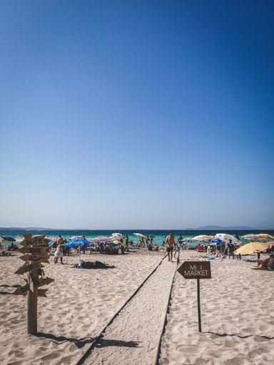 A vertical shot of the Izmir beach with many people relaxing in Turkey