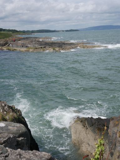 Rough sea with waves crashing against a rocky shore