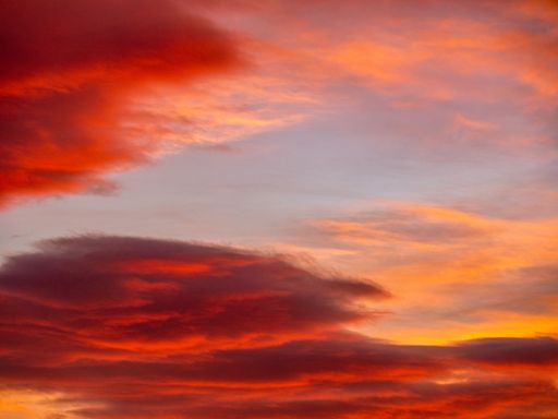 Vivid sunset sky with dramatic red and orange clouds creating a stunning natural scene.