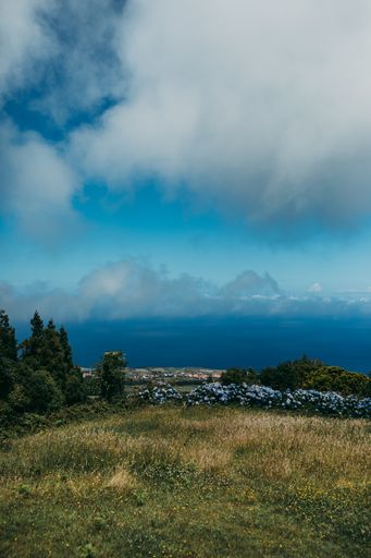 A scenic cloudscape over the sea and waterside landscapes