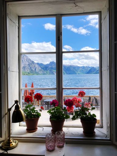 Looking through window with flowers on lake Traunsee, Gmunden - Upper Austria