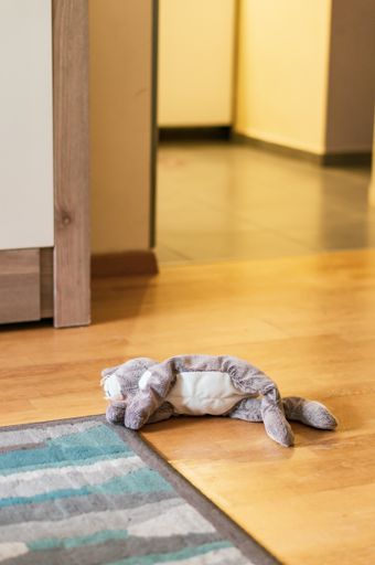 A vertical shot of a toy animal laying on the floor in Poznan, Poland -