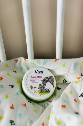 A Cien baby skin cream on a bed