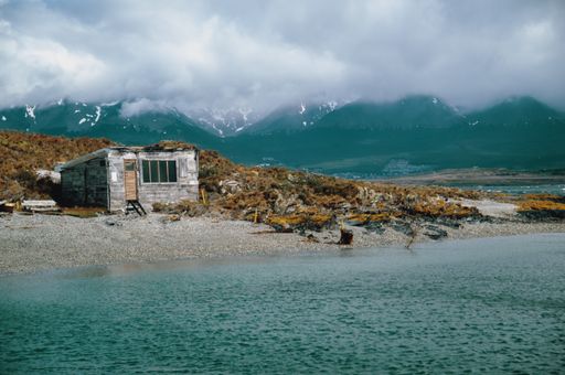 An abandoned wooden hut on an island on a foggy day