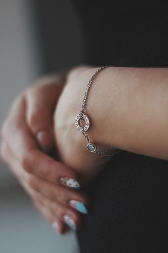 A vertical shot of a young female wearing a beautiful silver bracelet