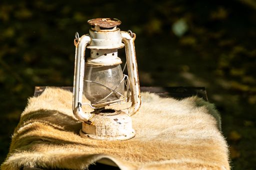 An old and rusty candle on an animal skin, decoration for historical parties
