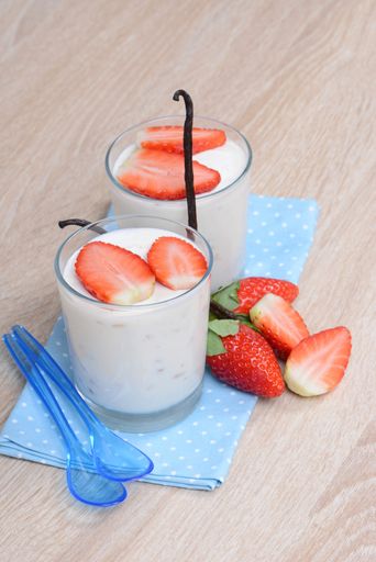 Yogurt with fresh straberries in glasses, wodden background, empty copy space for text