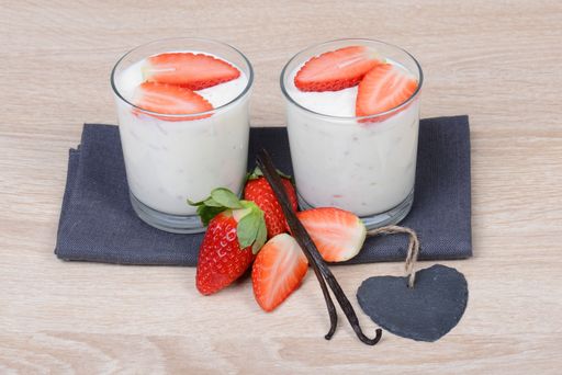 Yogurt with fresh straberries in glasses, wodden background, empty copy space for text