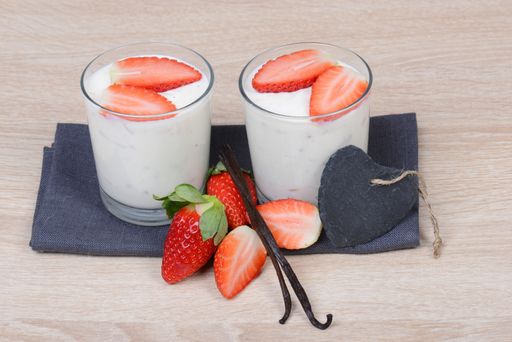 Yogurt with fresh straberries in glasses, wodden background, empty copy space for text