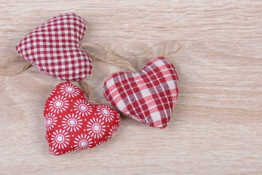 A collection of different decorated hearts on a wooden background for valentine's day