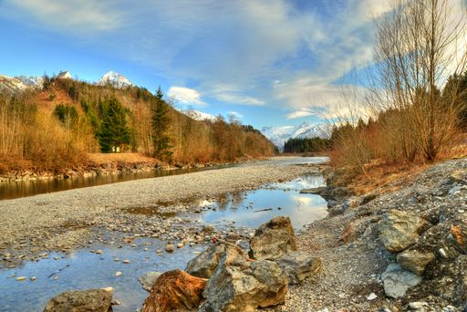 Landscape in the Allgaeu, near Fuessen in Germany, river with snow covered mountains, alps