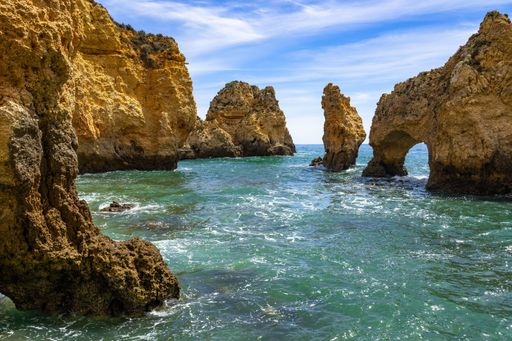 The cliffs of the Ponta da Piedade in Algarve region, Portugal under a blue sky