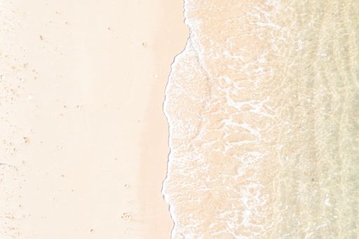 A paradisiac beach of turquoise waters from a zenithal drone view, summer concept background
