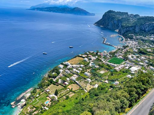 An aerial shot of the shore of Capri and the calm Tyrrhenian Sea from Italy