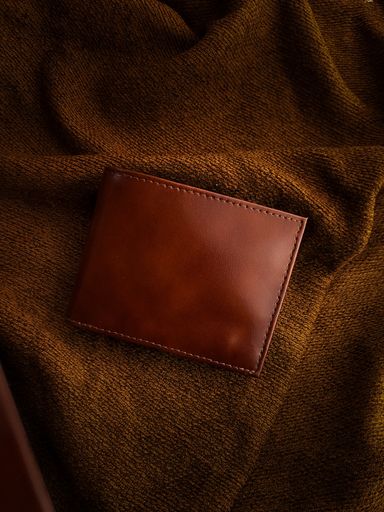 A brown wallet on brown fabric