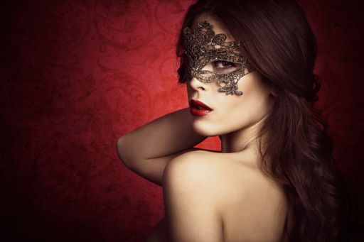 sensual beautiful young woman with lace mask, studio shot